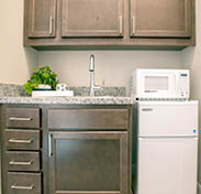 A kitchen with a microwave and a toaster oven. AI generated content