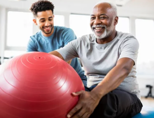 Two men are playing with a large red ball in a gym. AI generated content
