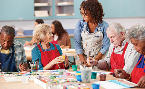 A group of people are painting at a table. AI generated content